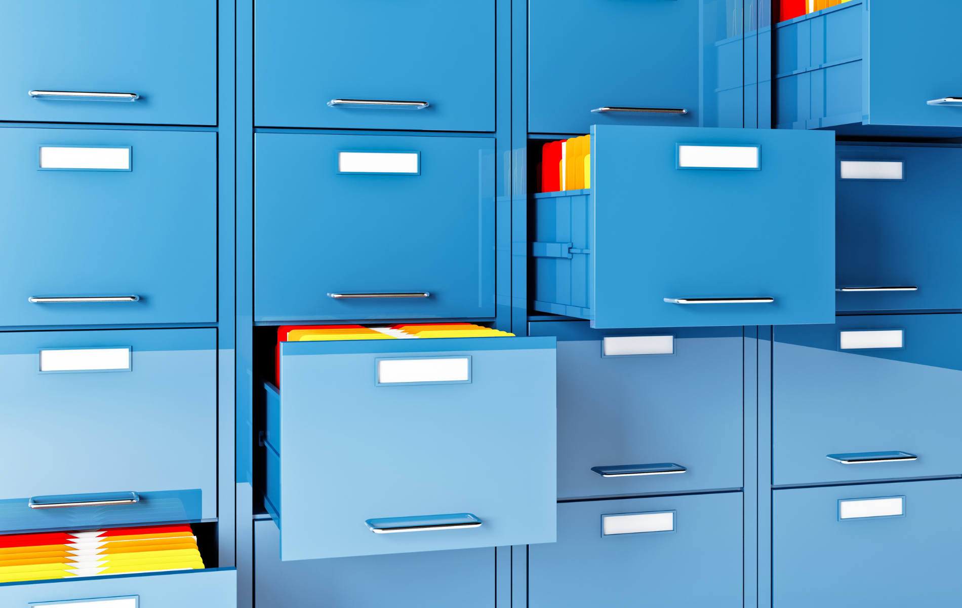 A row of blue filing cabinets with one drawer open