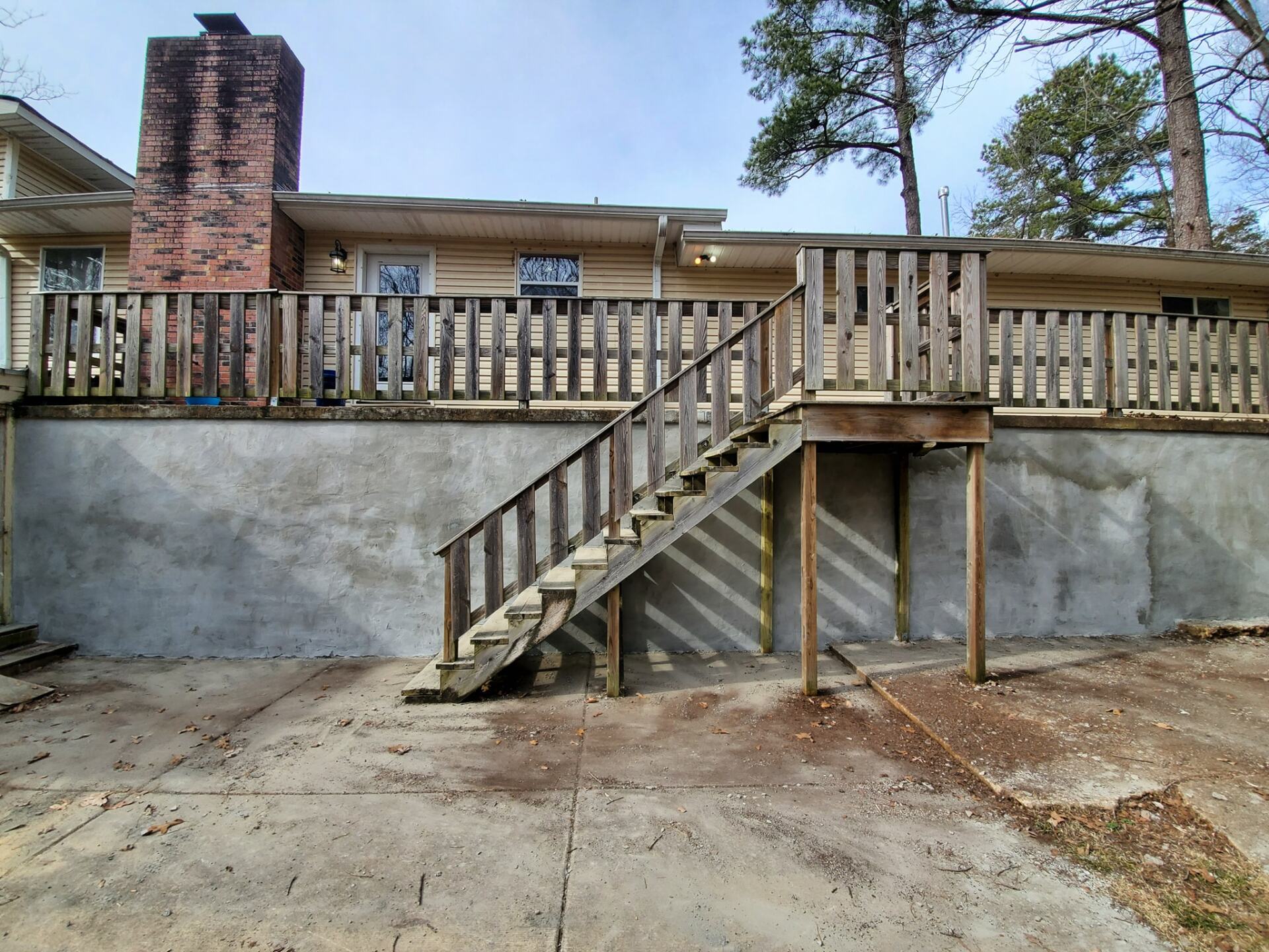 A house with a deck and stairs leading up to it