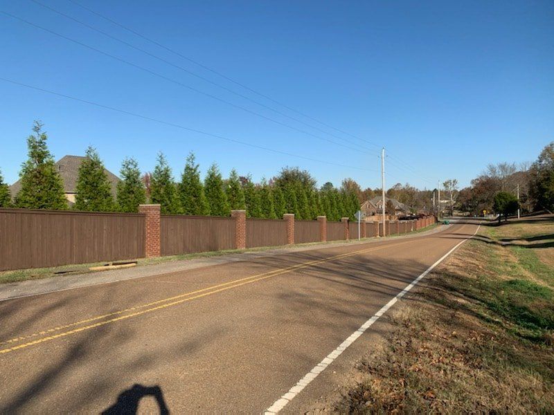 A road with a wooden fence along the side of it