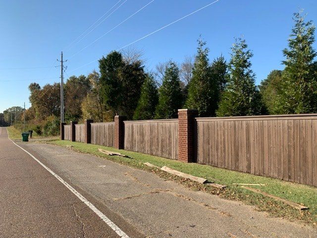 A wooden fence along the side of a road
