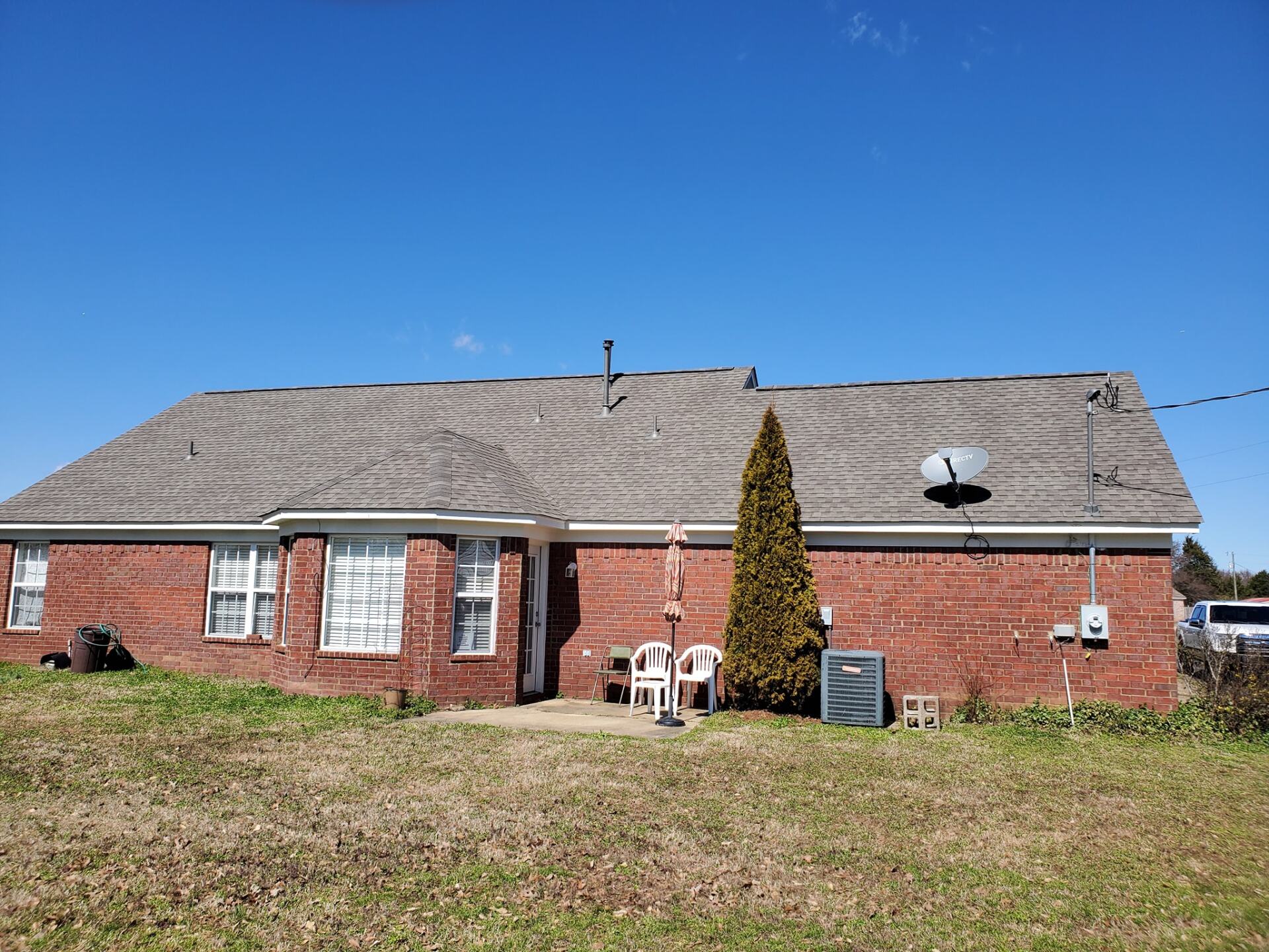 A brick house with a satellite dish on the roof