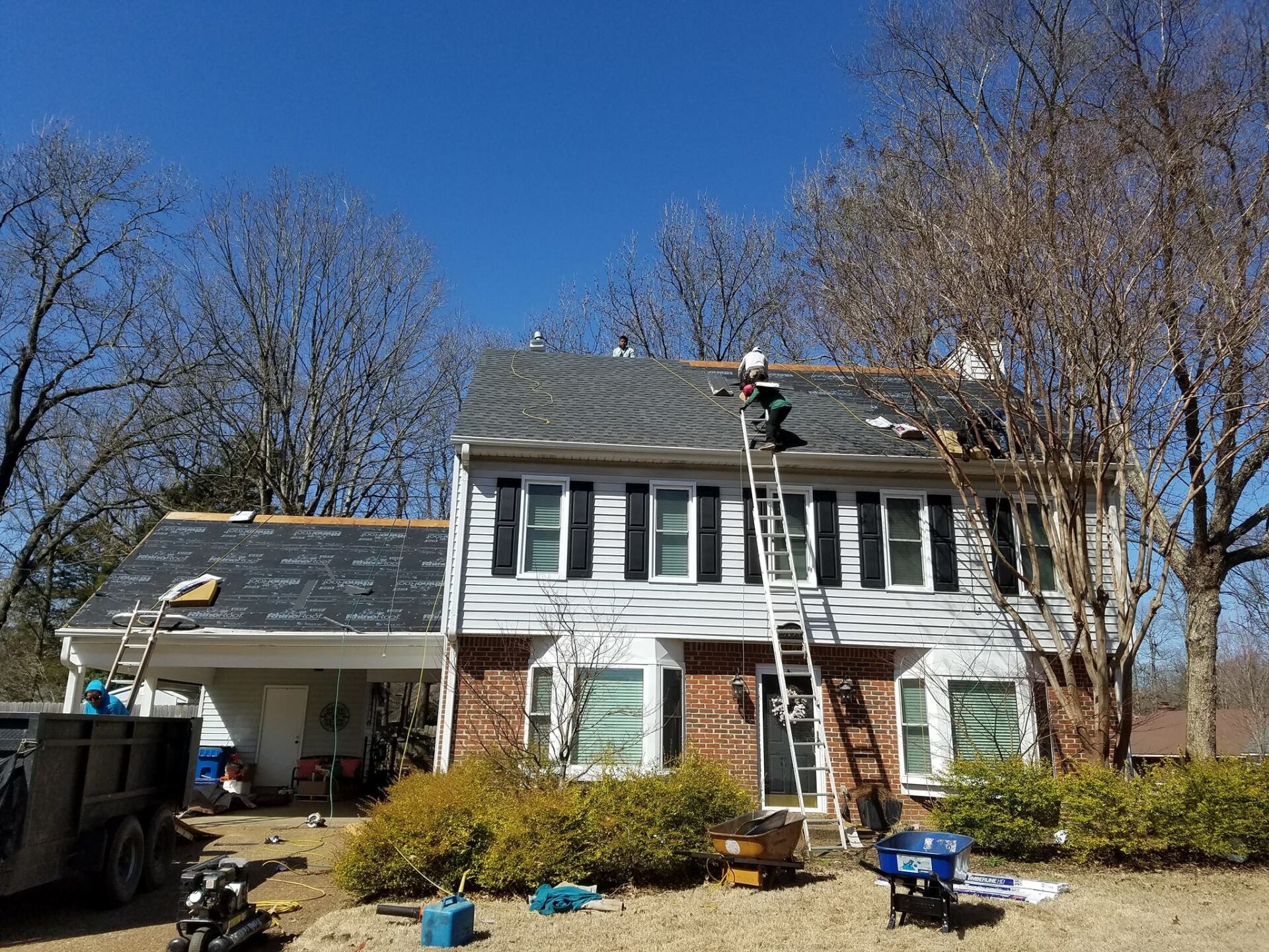A man is working on the roof of a house.
