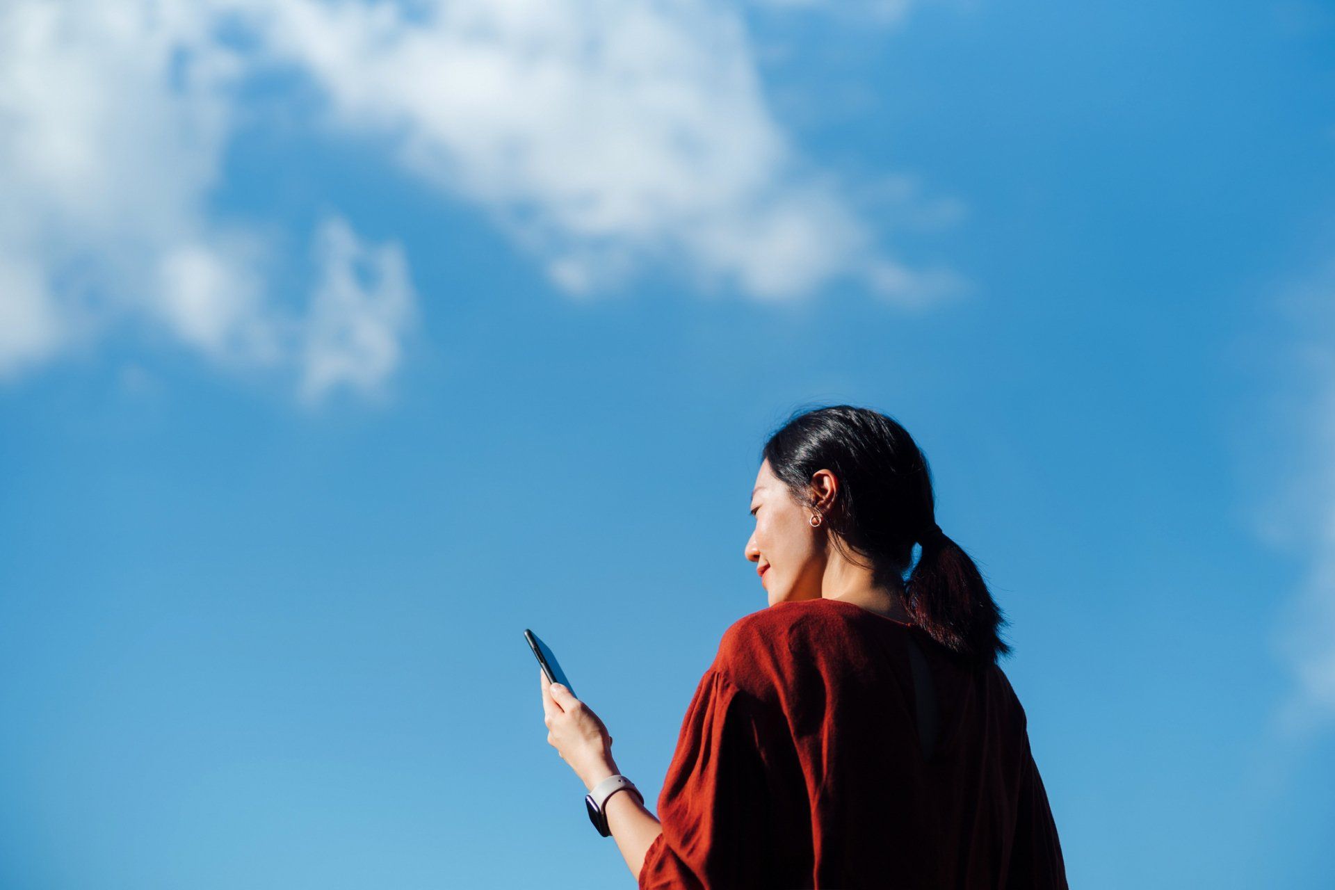 Woman Holding A Phone — Downers Grove, IL — T. B. Kulat