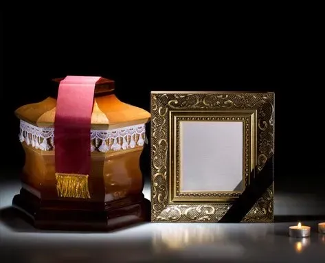there is a picture frame and candles on the table .