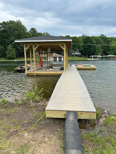 A wooden dock is sitting in the middle of a lake.