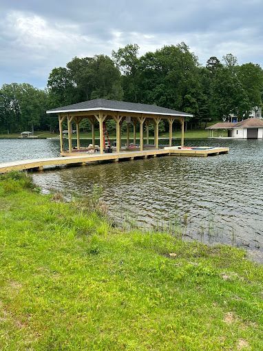 A wooden dock is sitting on the shore of a lake.