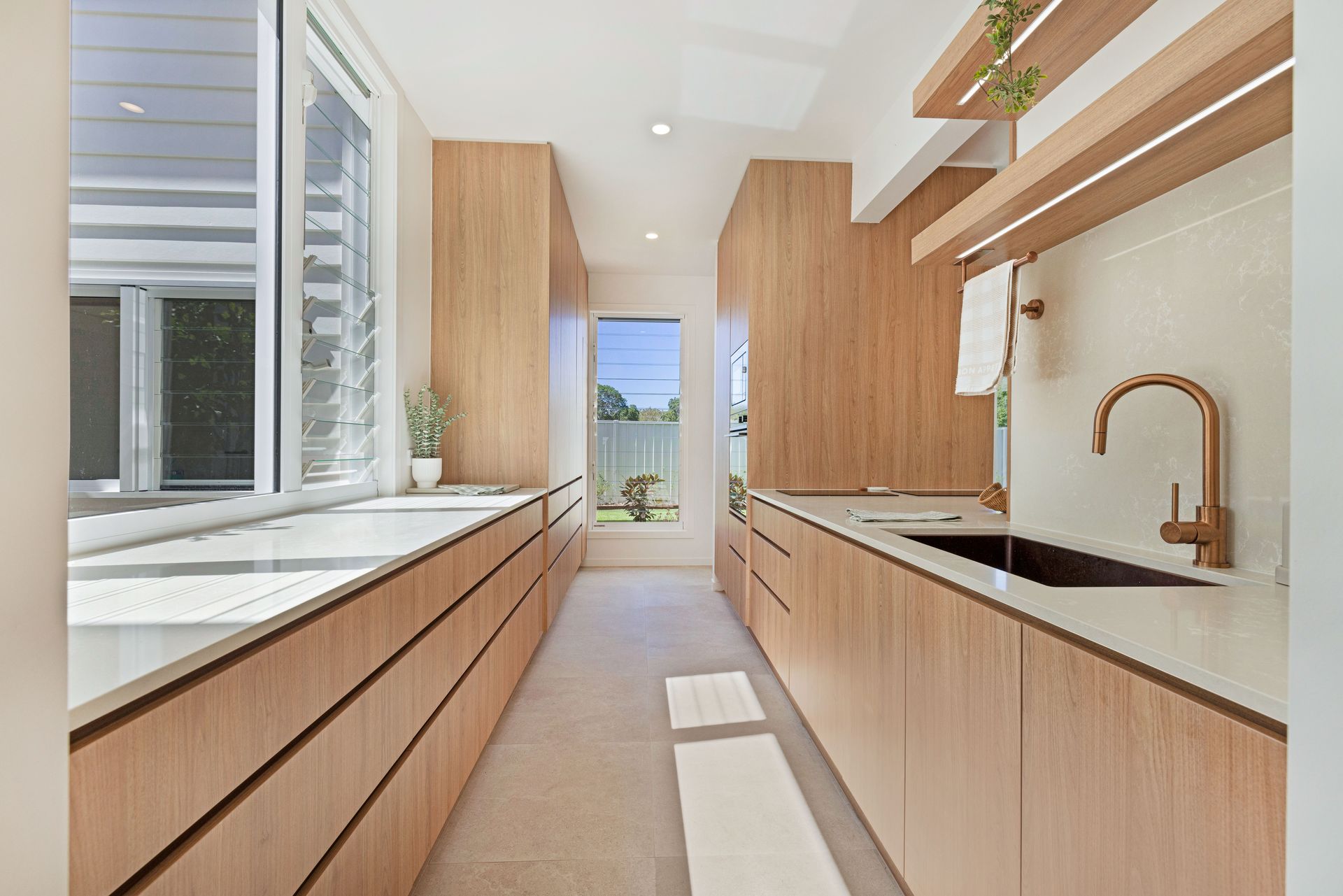 Modern Bedroom With Light Wood Built-ins and Large Windows — Master Cabinets Bundaberg in Kensington, QLD