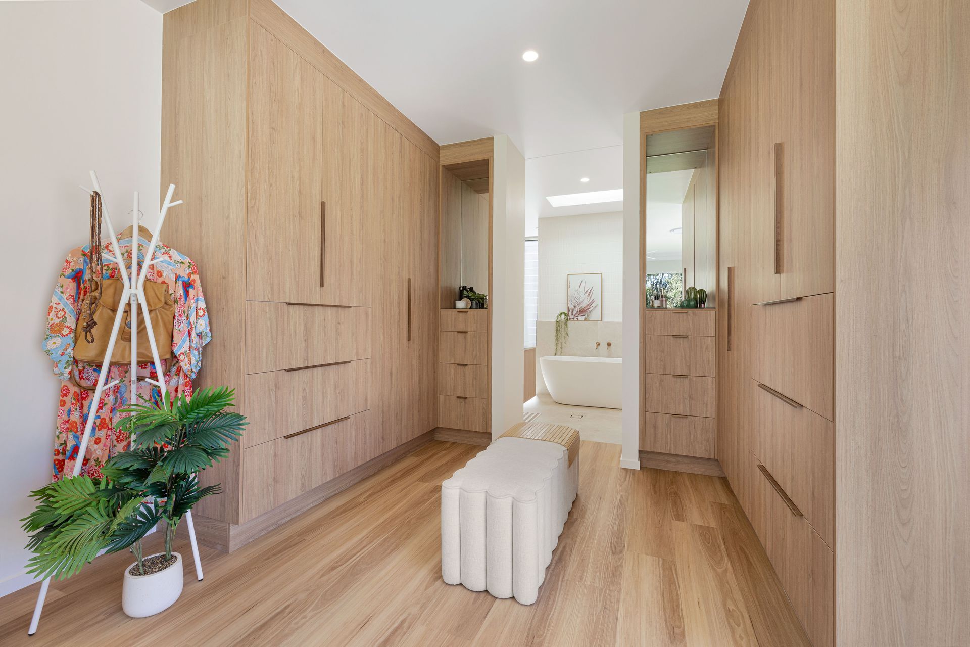 Walk-in Closet With Neutral-toned Clothes, Shelves, And Drawers — Master Cabinets Bundaberg in Kensington, QLD