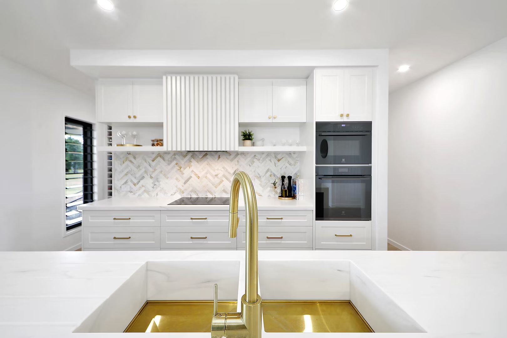 A Kitchen With Wooden Cabinets And White Counter Tops — Master Cabinets Bundaberg in Burnett Heads, QLD