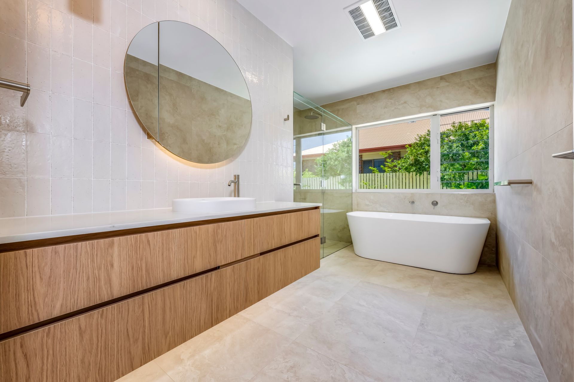 Modern Bathroom With Circular Mirror, Double Sinks, and Wooden Cabinets — Master Cabinets Bundaberg in Kensington, QLD