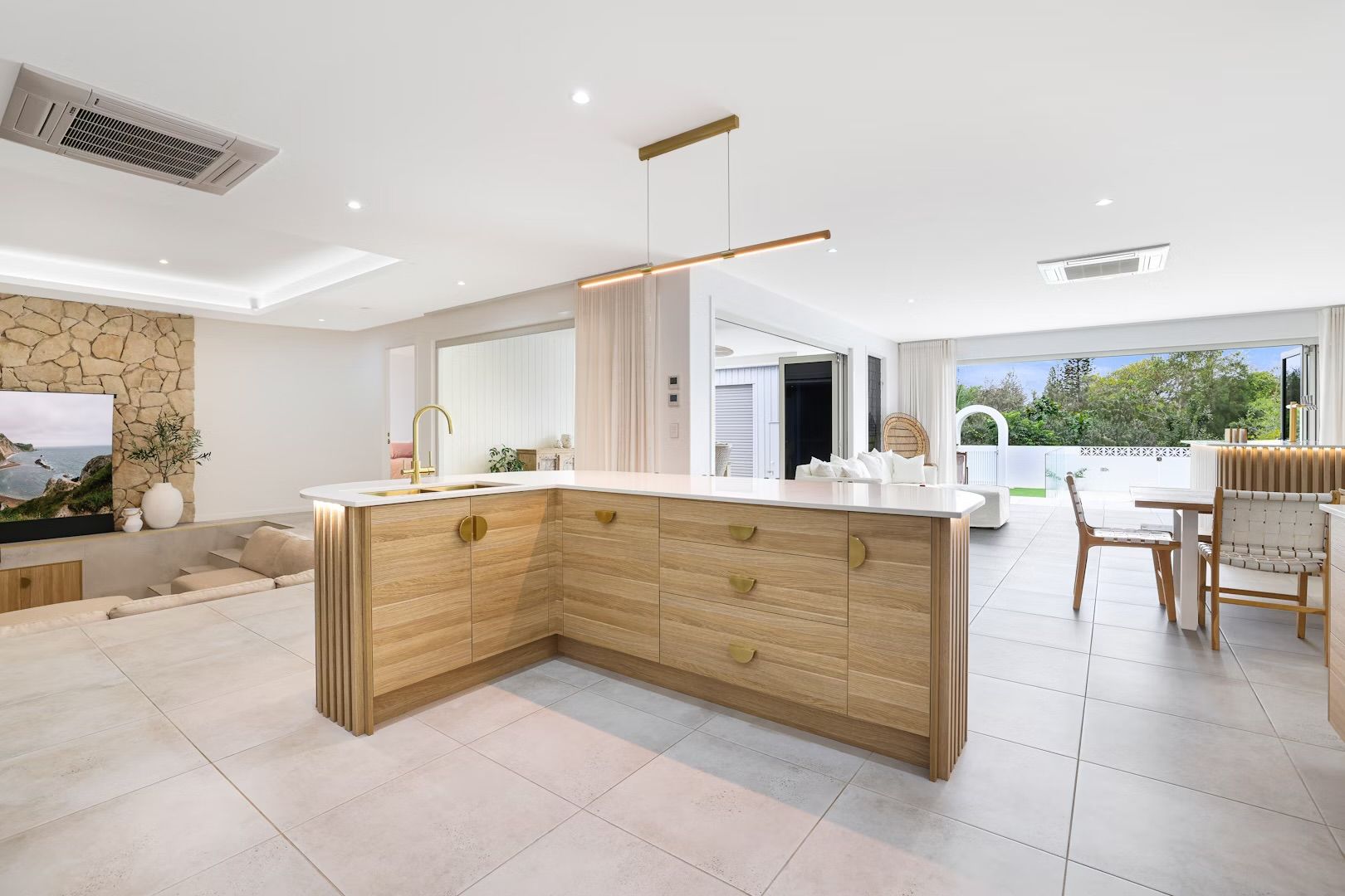 Modern White Kitchen With Large Island, Bar Stools — Master Cabinets Bundaberg in Kensington, QLD