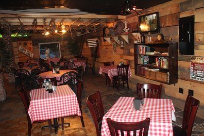 A restaurant with red and white checkered tables and chairs