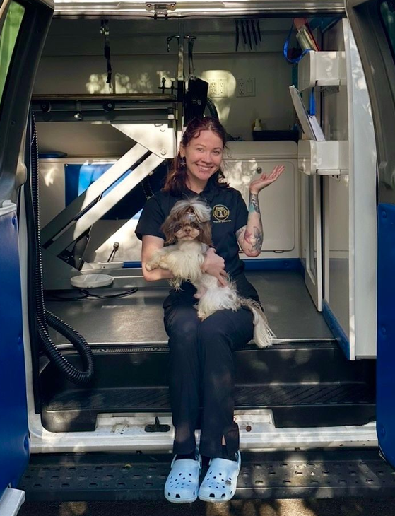 Ottillie holding her Shih Tzu Roman on the steps of Roman’s Empire’s Mobile Grooming van in Granite Bay, CA.
