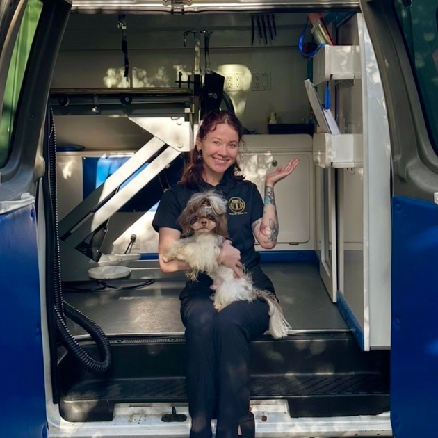Mobile dog and cat grooming salon -- Roman's Empire, Folsom CA Ottillie holding her Shih Tzu Roman on the steps of Roman’s Empire’s Mobile Grooming van in Granite Bay, CA.