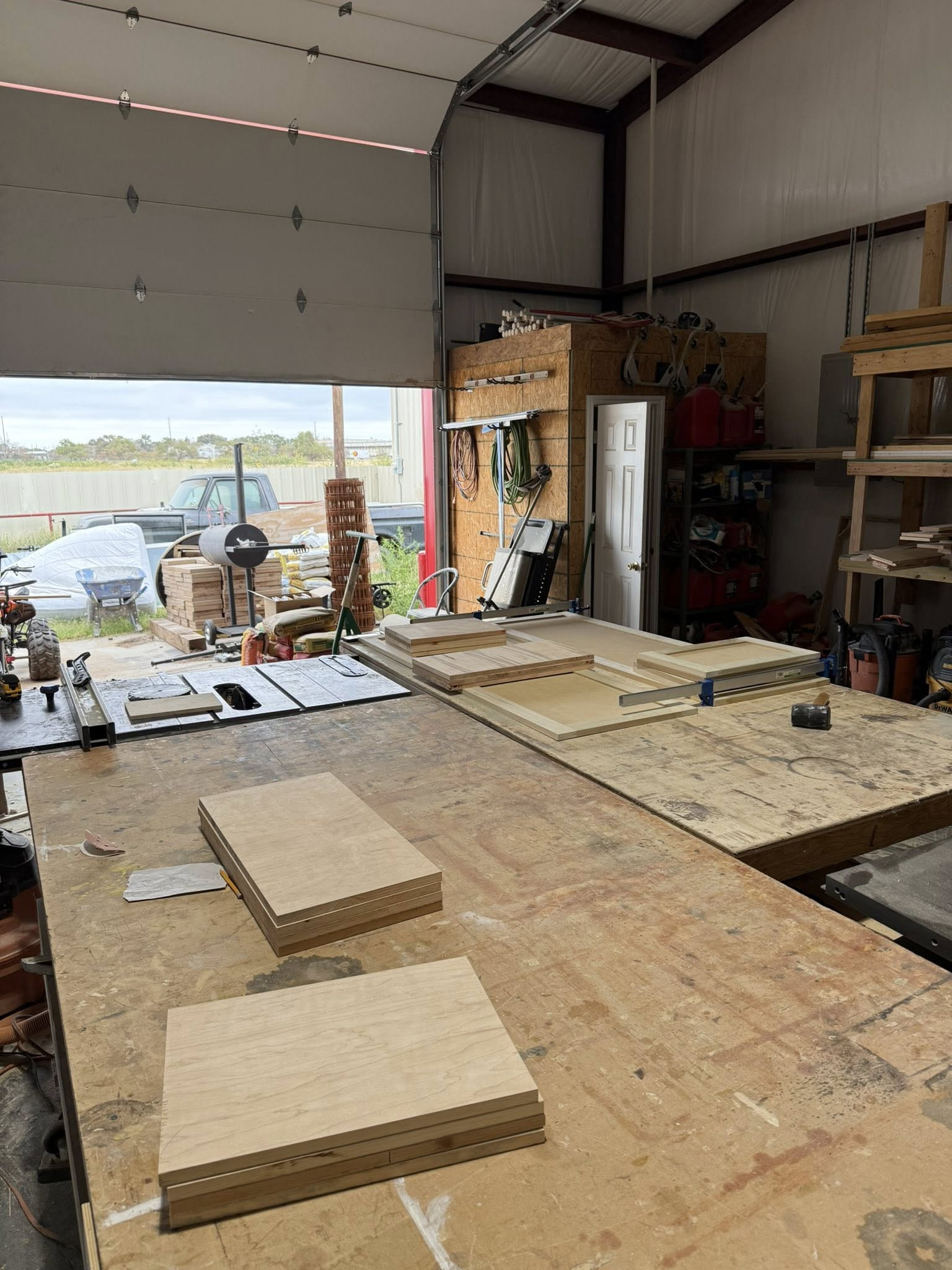 Workshop interior: Two wood blocks sit on a large workbench, with other tools and materials visible.
