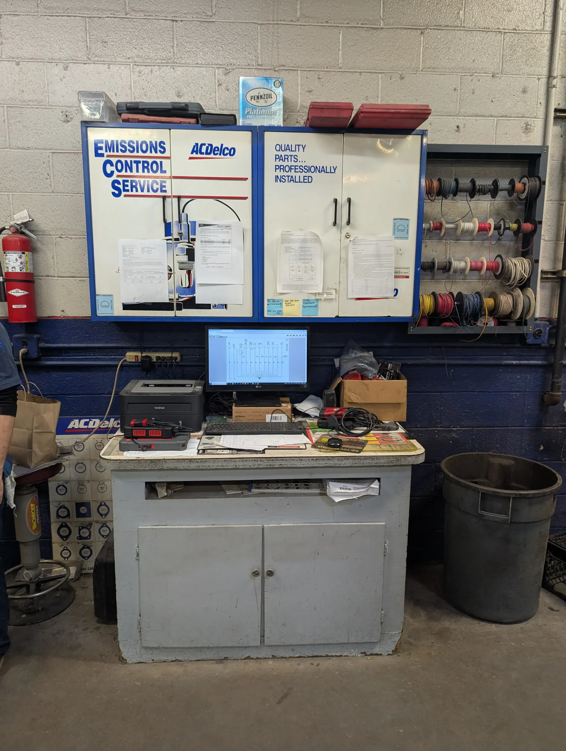 Workstation in an auto shop with emissions control service display, computer, and tools | Rymer Automotive