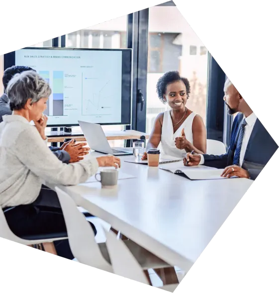 A group of people are sitting around a table having a meeting.
