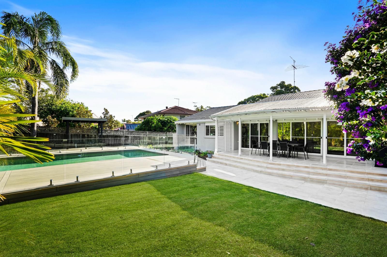 A large house with a swimming pool in the backyard.