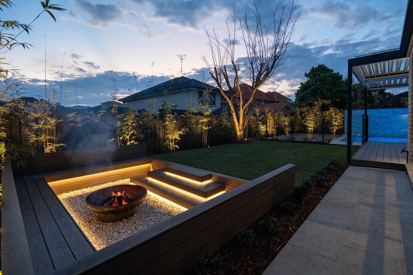 There is a fire pit in the middle of the backyard.