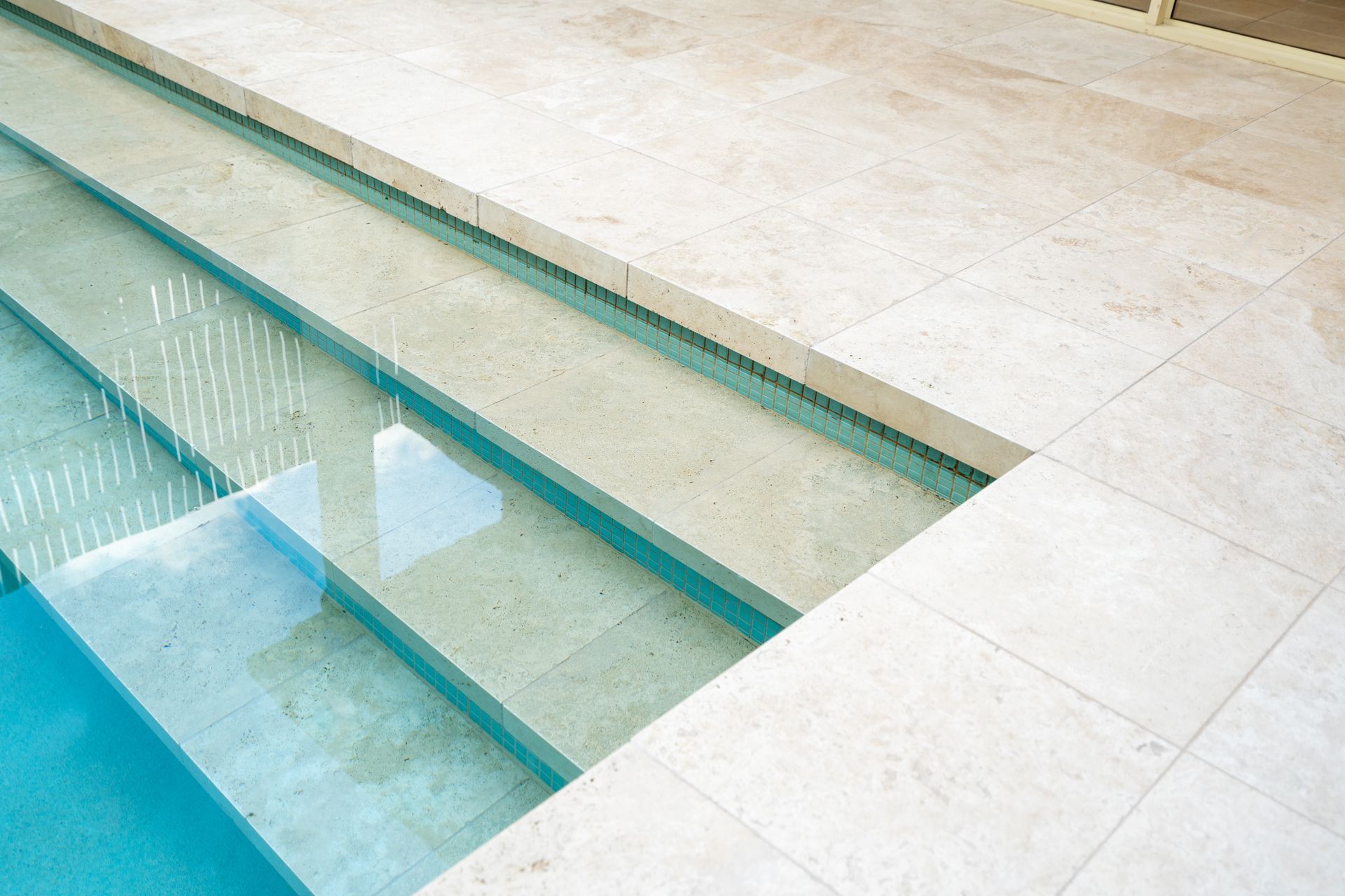 A swimming pool with stairs leading up to it