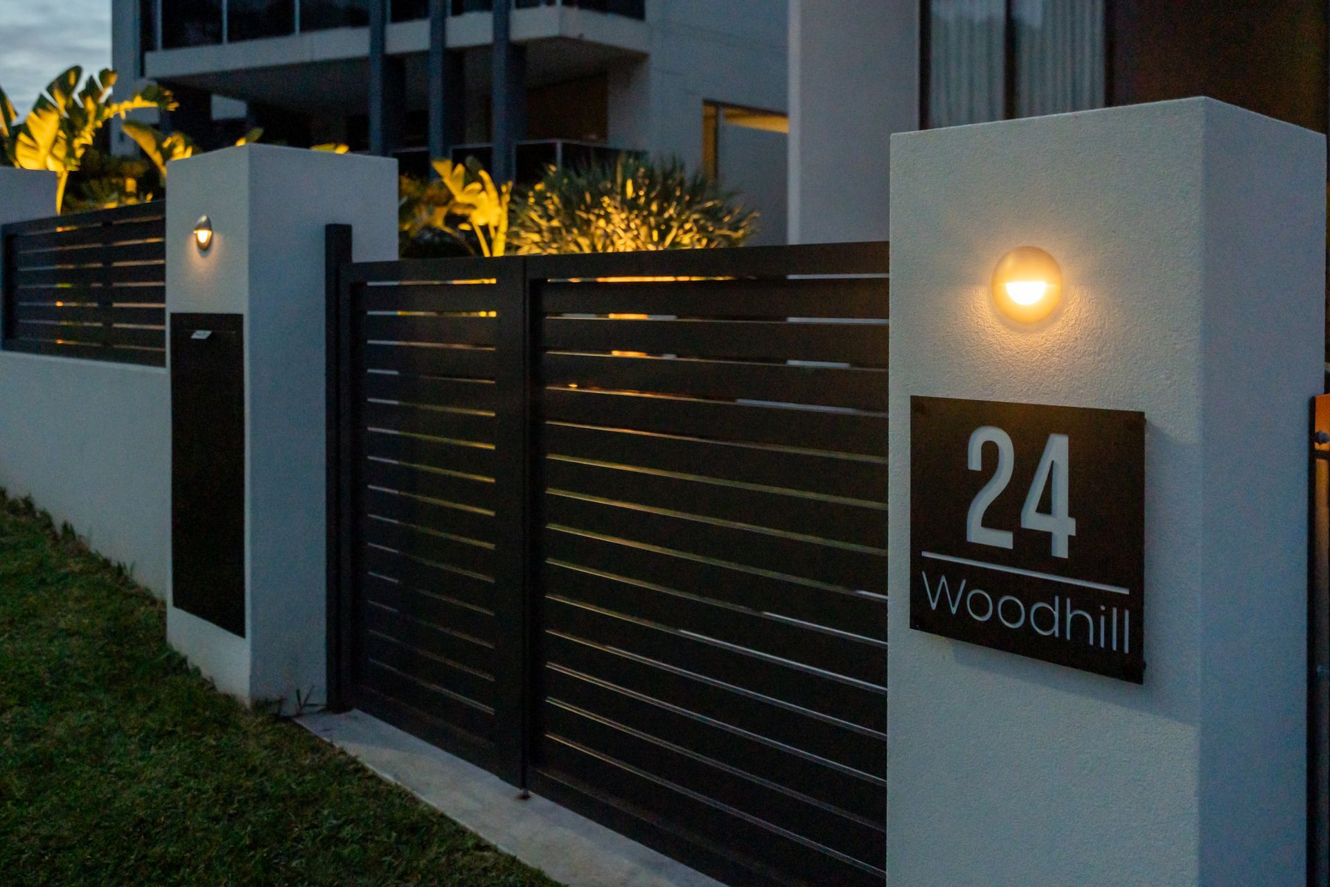 Black gated entrance with address 