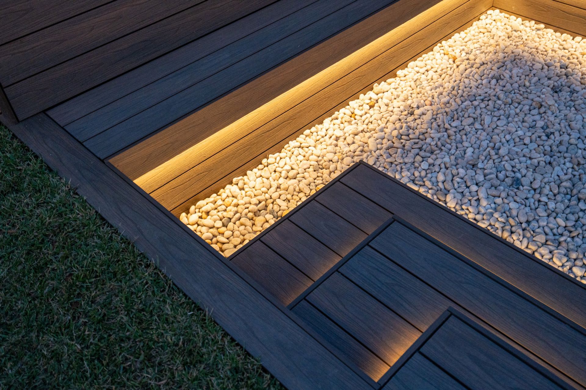 Composite deck with recessed lighting and gravel bed.