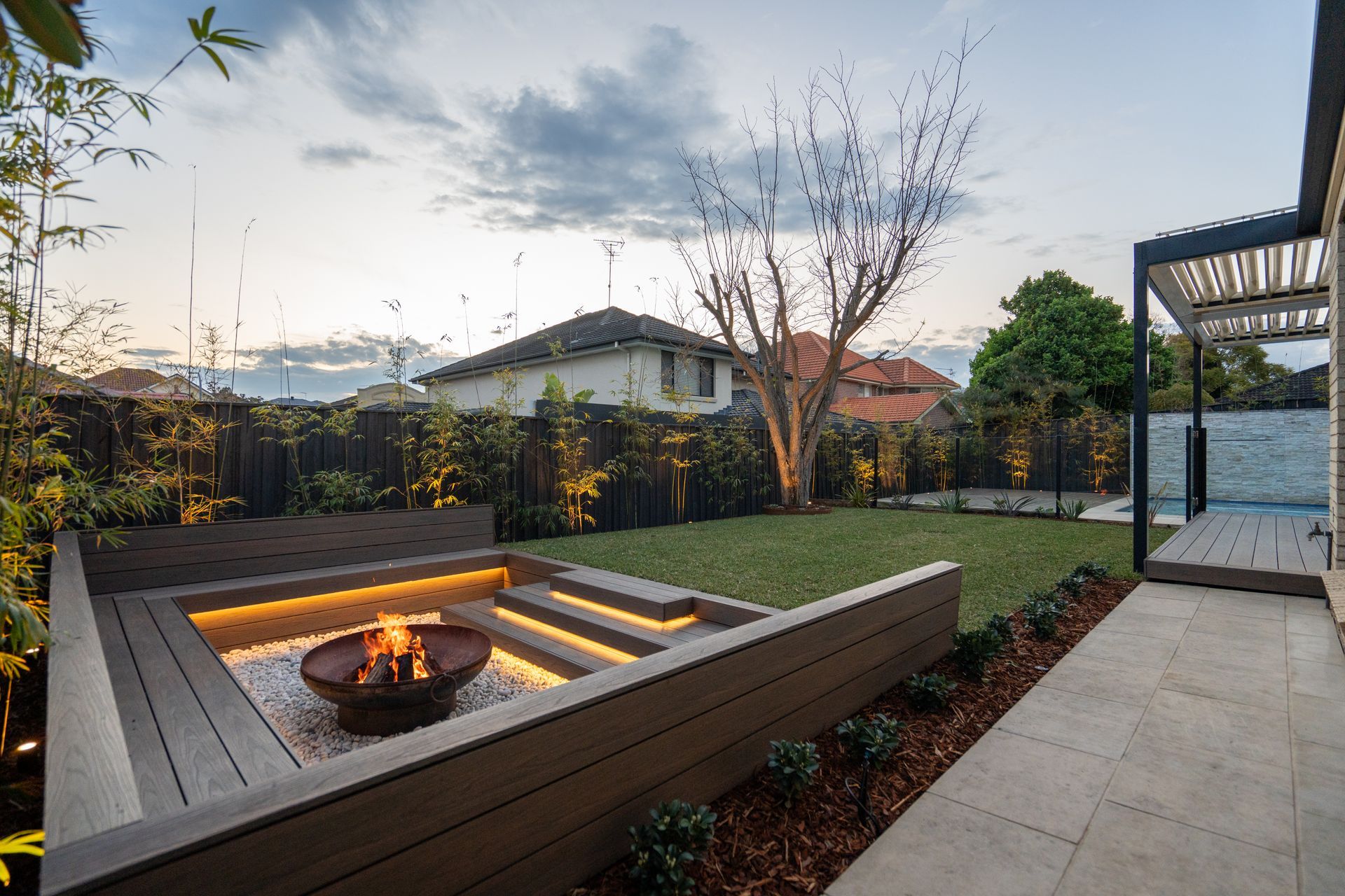 There is a fire pit in the middle of the backyard.