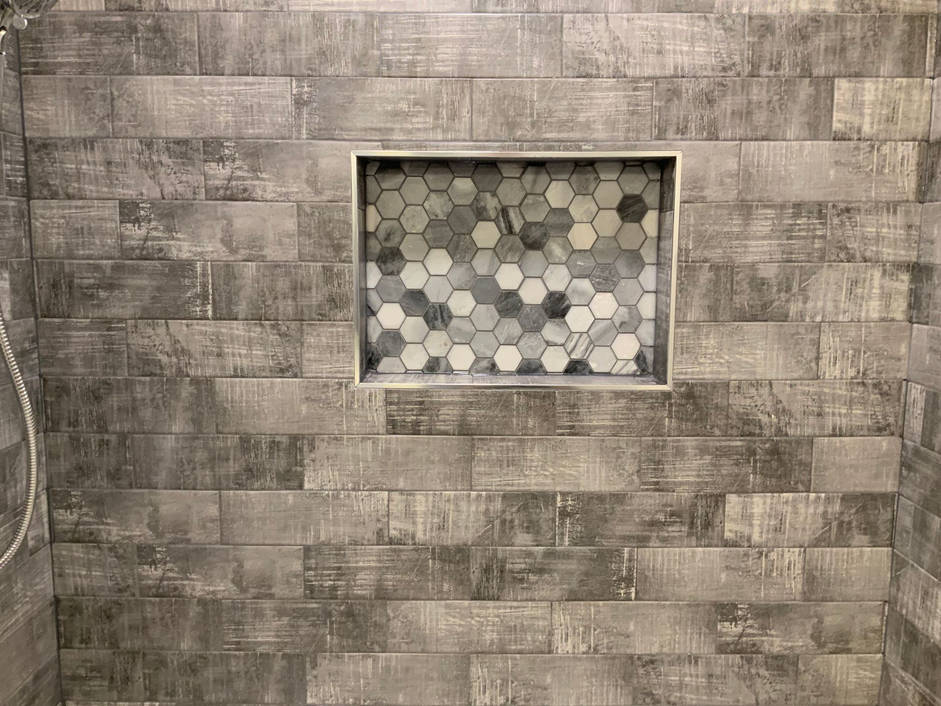 A shower with a tiled niche in the wall.