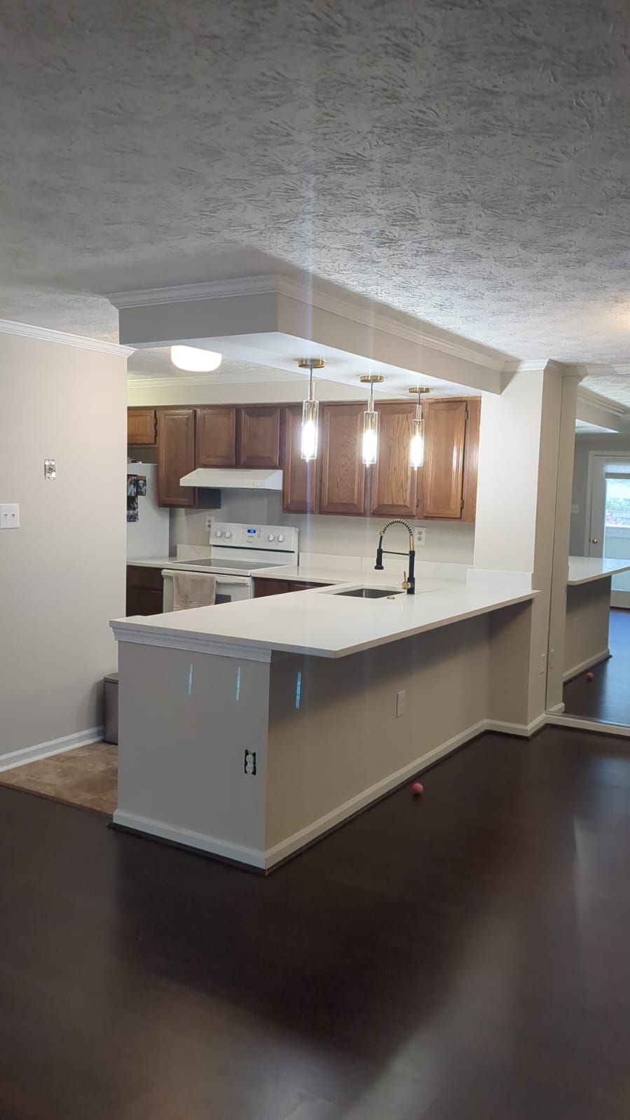 A kitchen with a large island and a sink in a house.