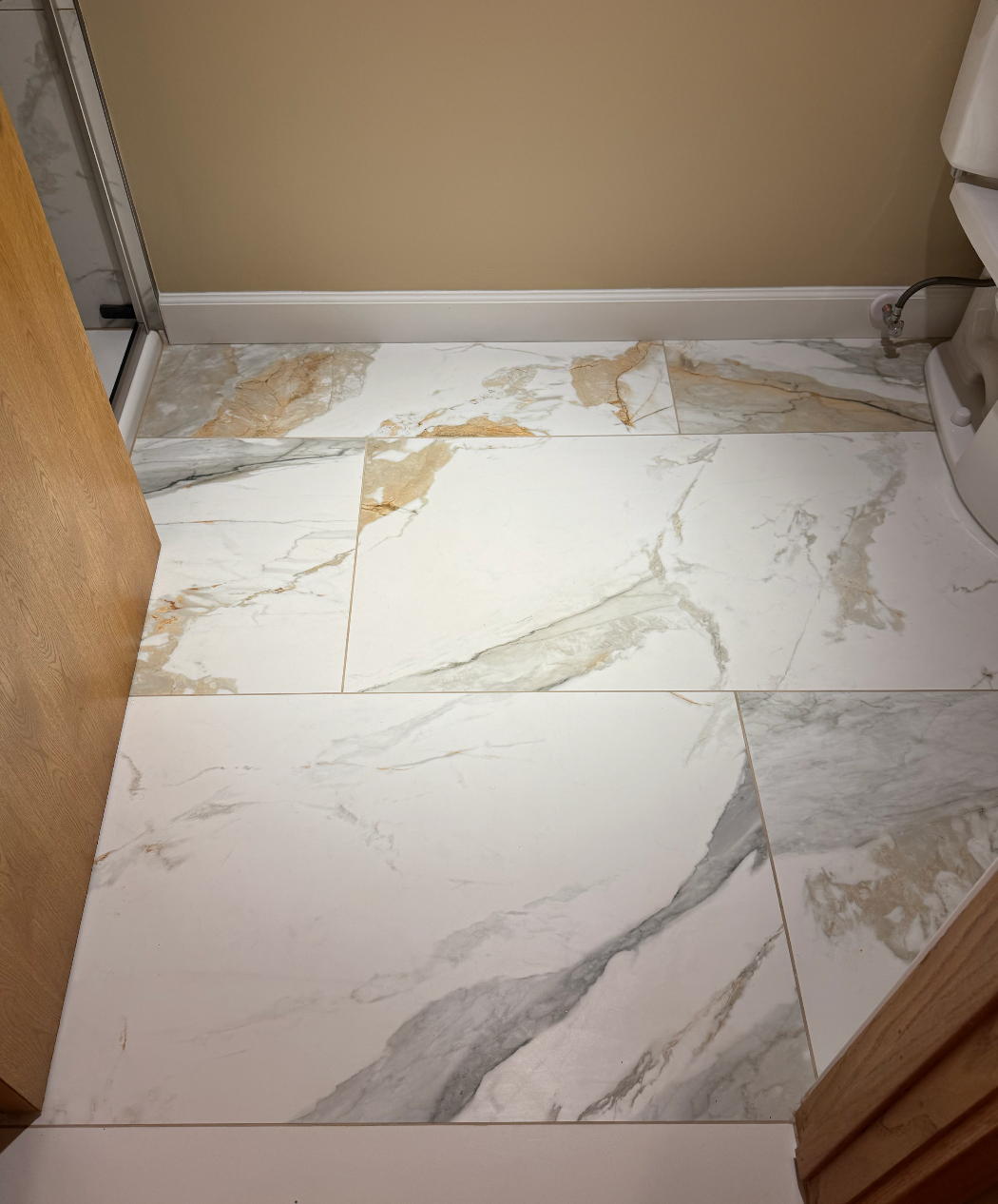 Marble-pattern tile floor in a small bathroom doorway.