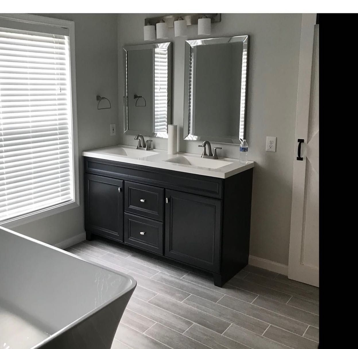 A bathroom with two sinks and two mirrors