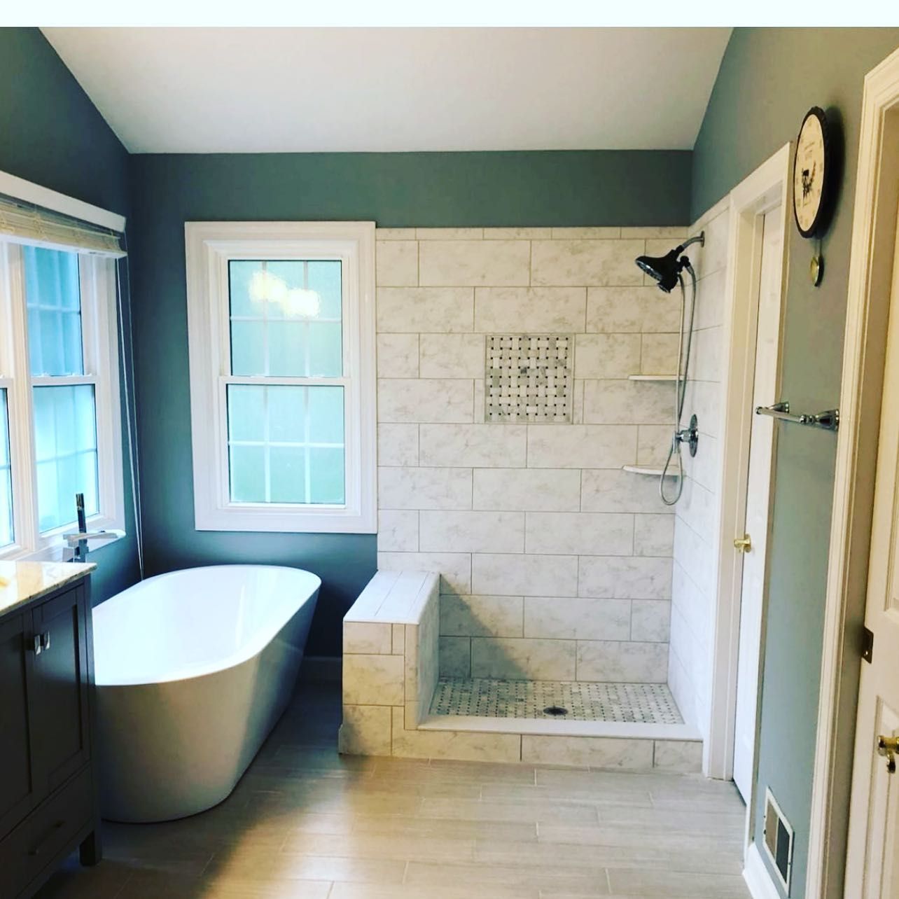 A bathroom with a tub and a walk in shower
