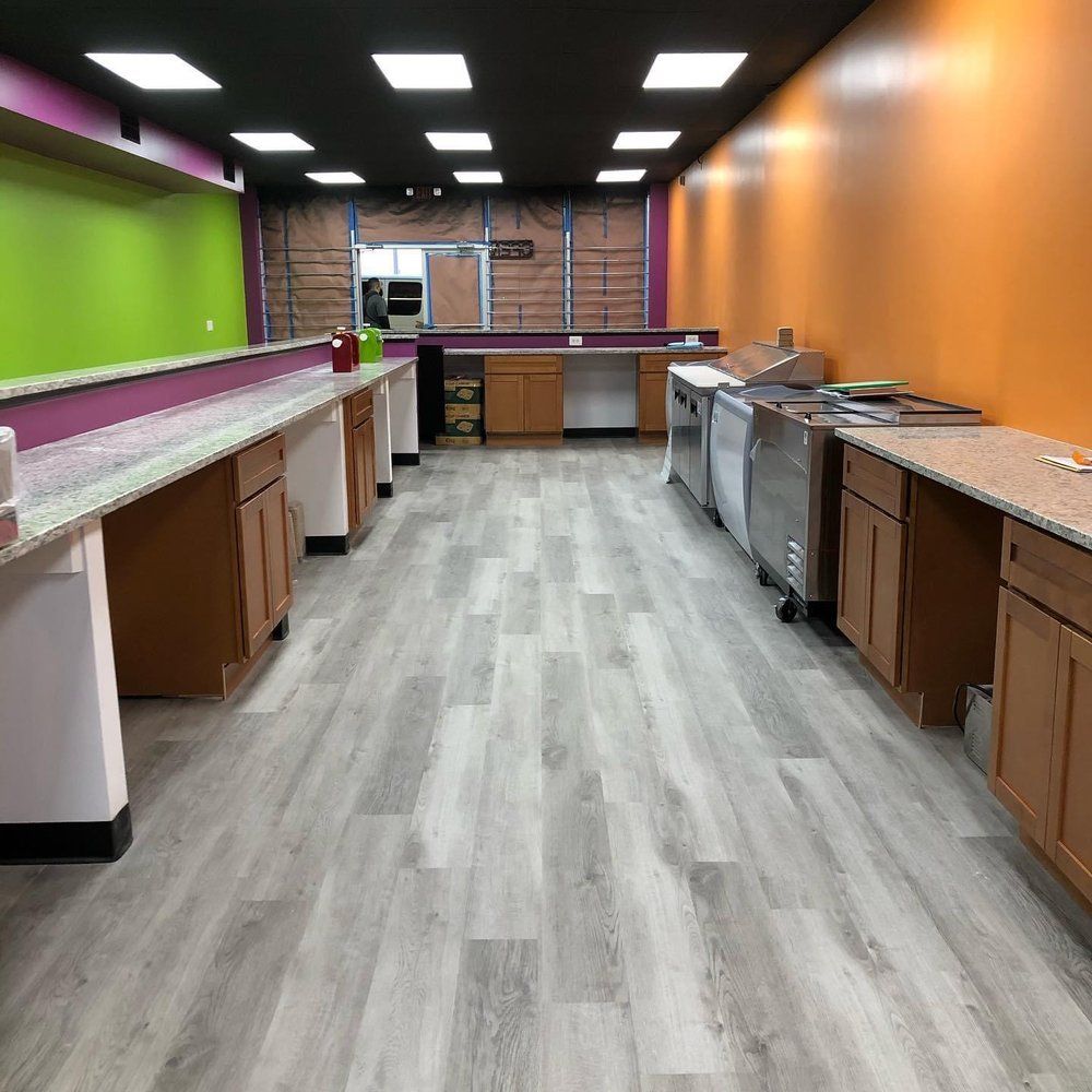 A large room with a lot of cabinets and counters