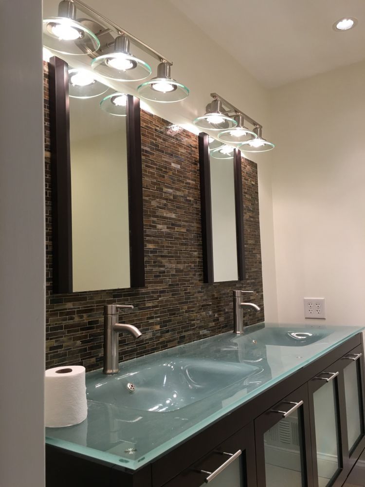 A bathroom with two sinks and two mirrors.