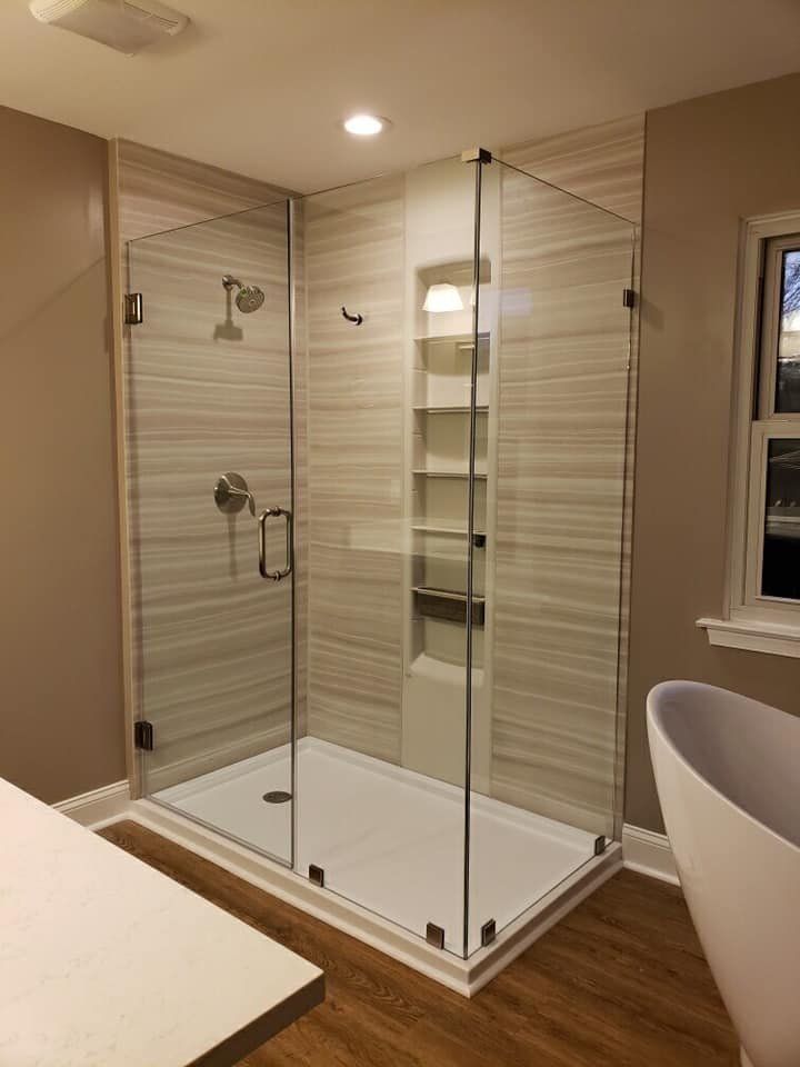 A bathroom with a walk in shower and a bathtub.