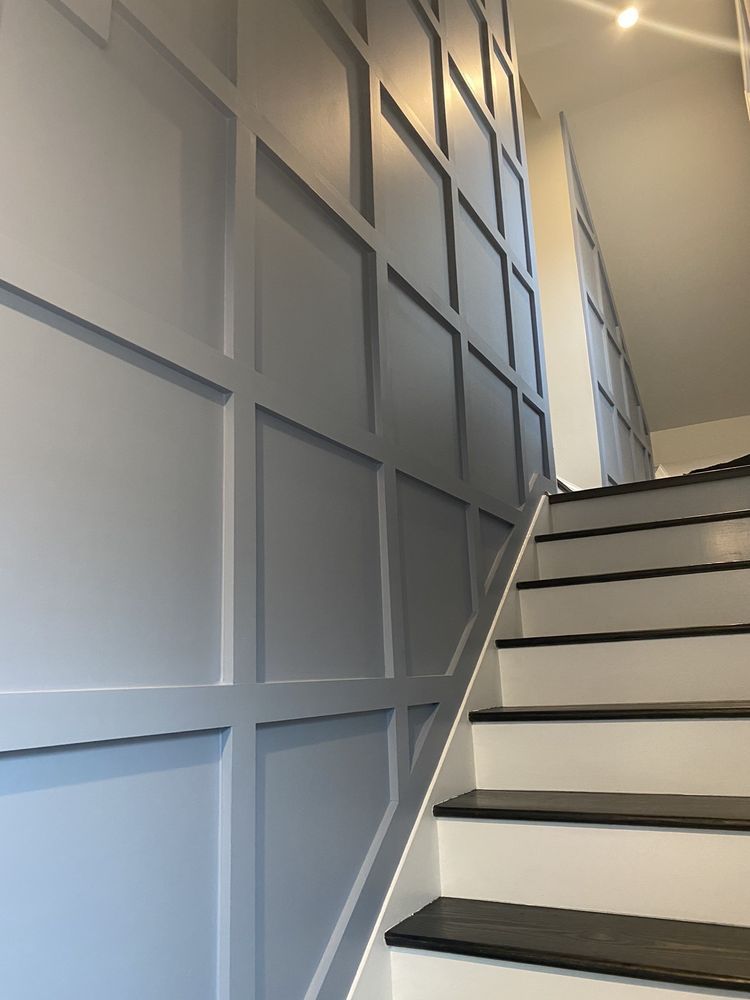 A set of stairs with a blue wall behind them