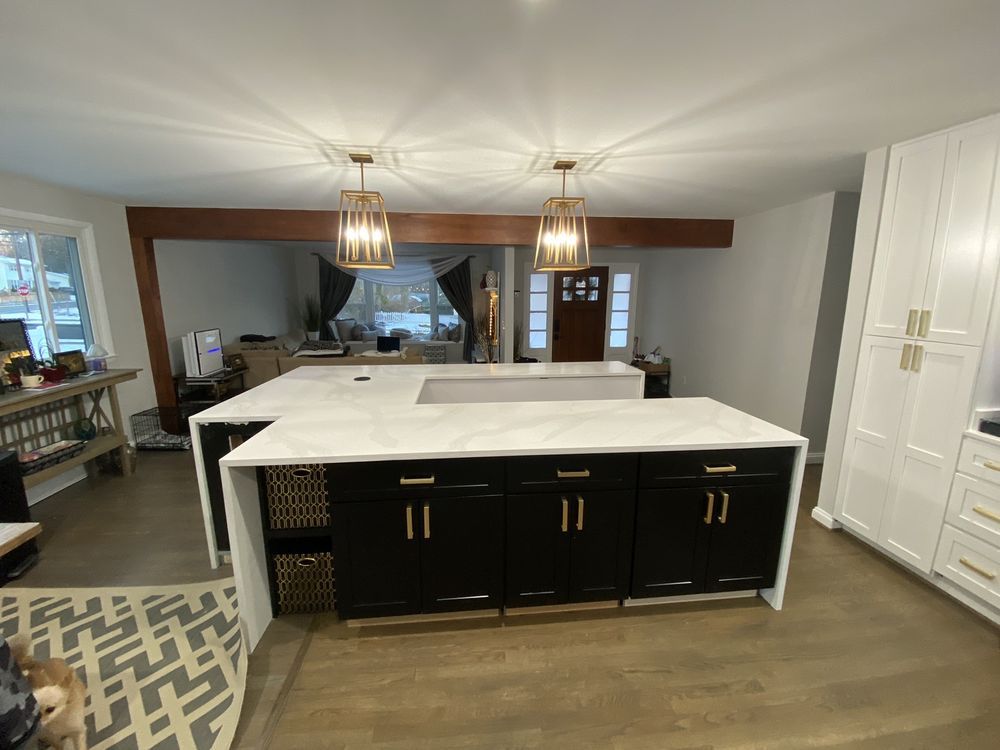 There is a large island in the middle of the kitchen.