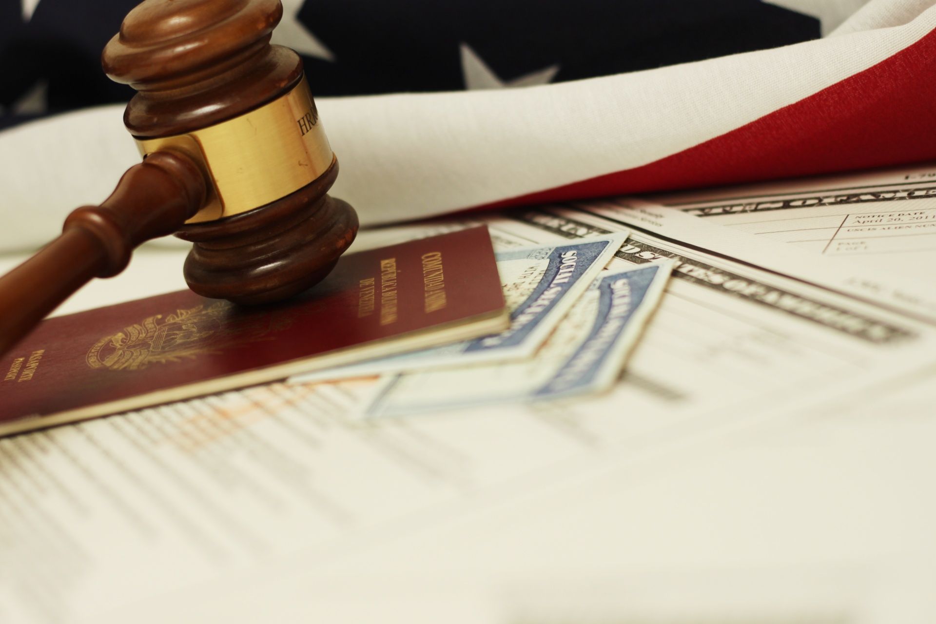 A judge 's gavel is sitting on top of a passport