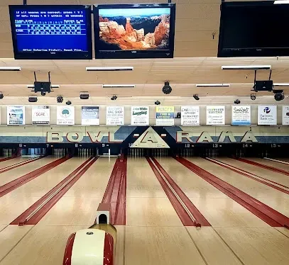 Bowling lanes inside Bowl A Rama with score monitors overhead