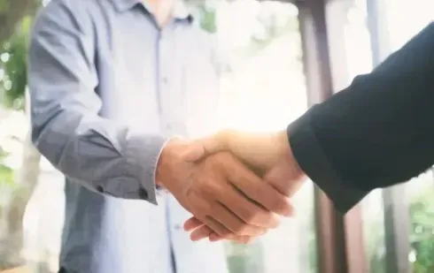 Chimney Sweep Portland - A man and a woman are shaking hands in front of a window.