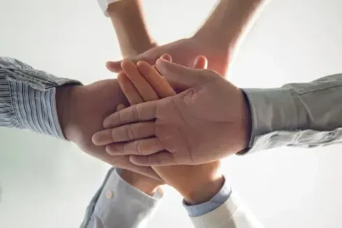 Chimney Sweep Portland - A group of people are putting their hands together.