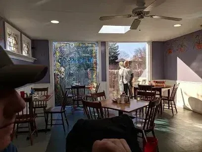 Chimney-Sweep-Portland-A restaurant with tables and chairs and a ceiling fan.