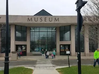 Chimney-Sweep-Portland-A group of people stand outside a museum entrance with the word
