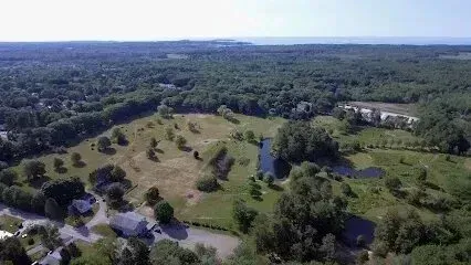 Chimney-Sweep-Portland-An aerial view of a golf course surrounded by trees and houses.