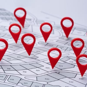 Red location pins on a folded map grid