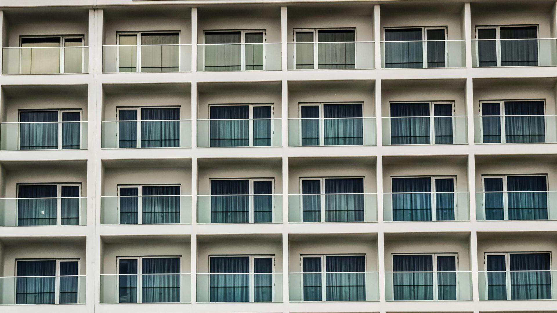 White building facade with rows of balconies