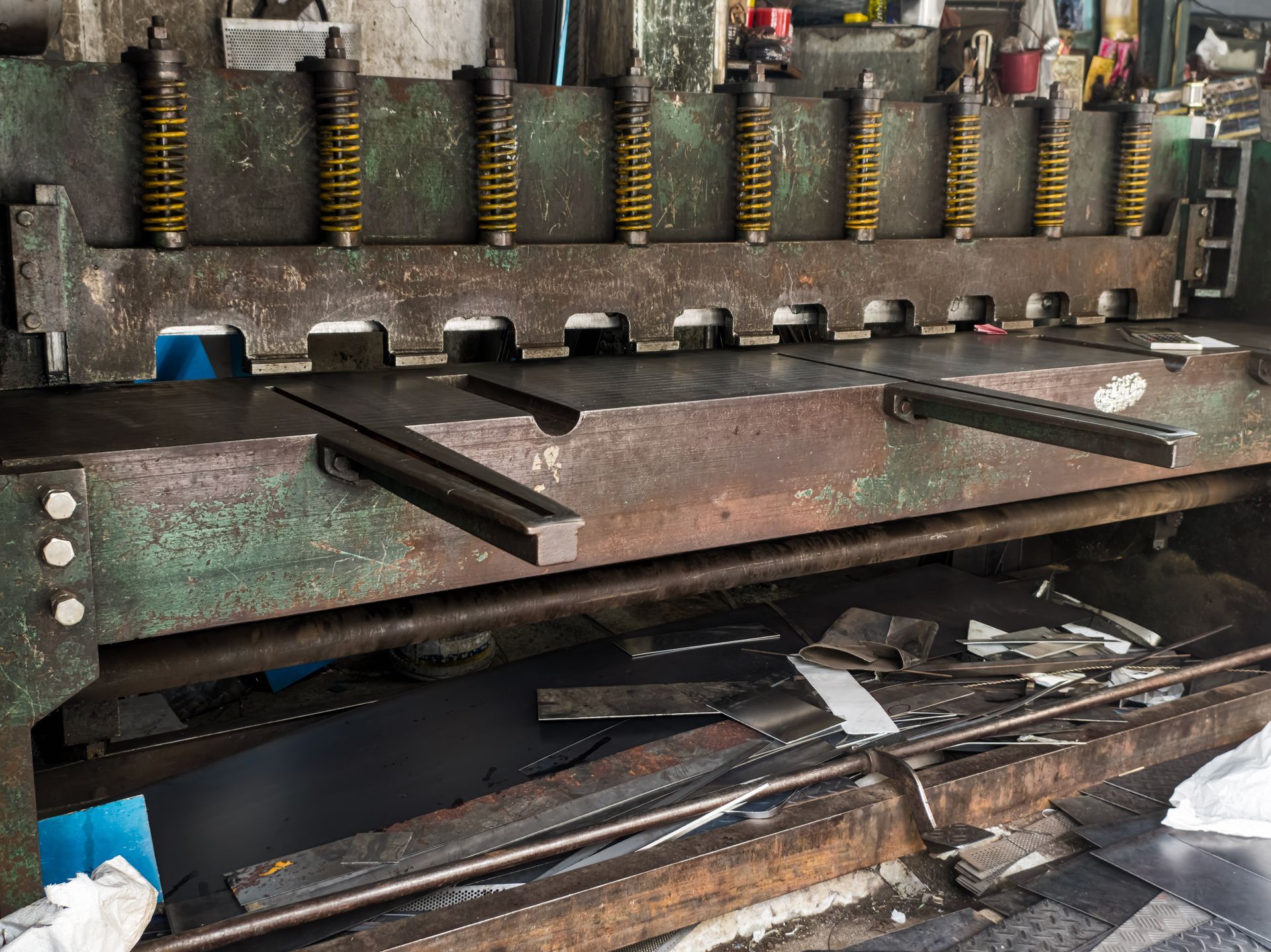 Metal shear machine cutting metal sheets. Industrial setting.
