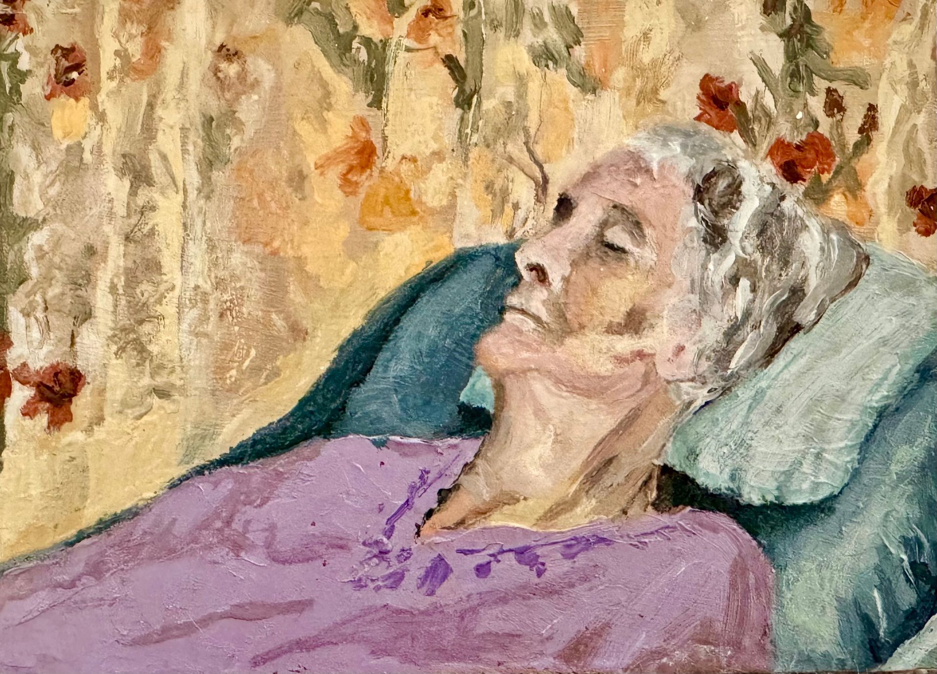 Elderly person resting on a chair in a purple blanket against a floral backdrop