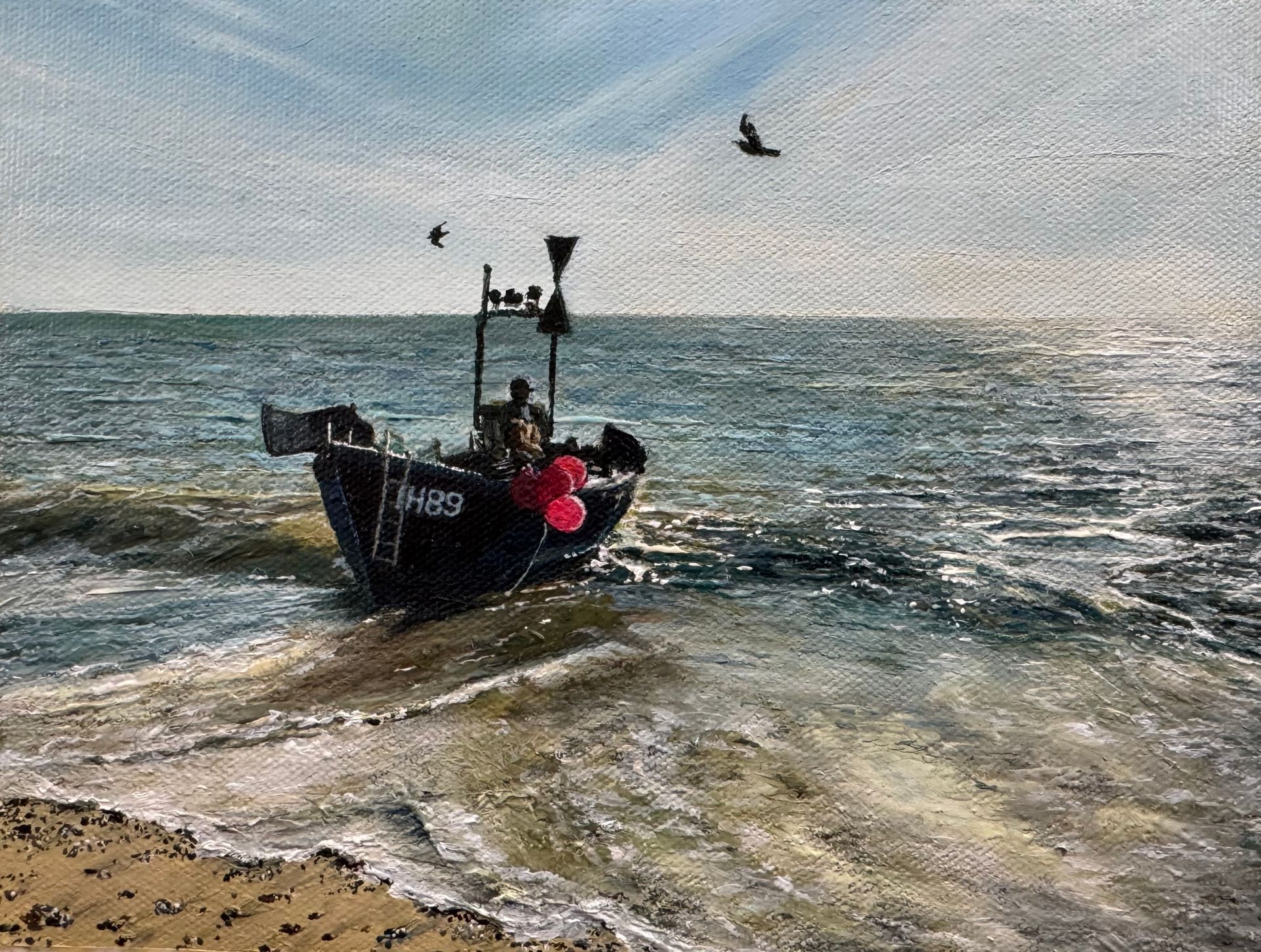 Small fishing boat with people on choppy water near shore, seagulls flying overhead at sunrise.