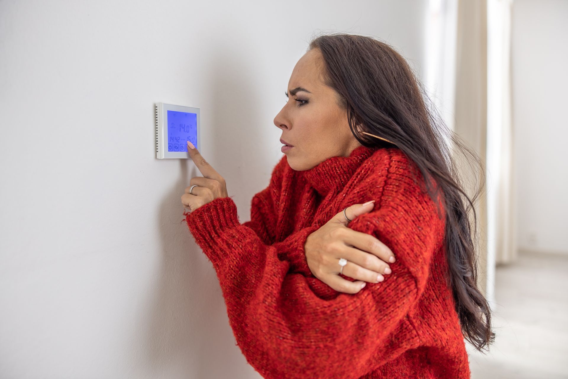 A man is installing a radiator in a room.